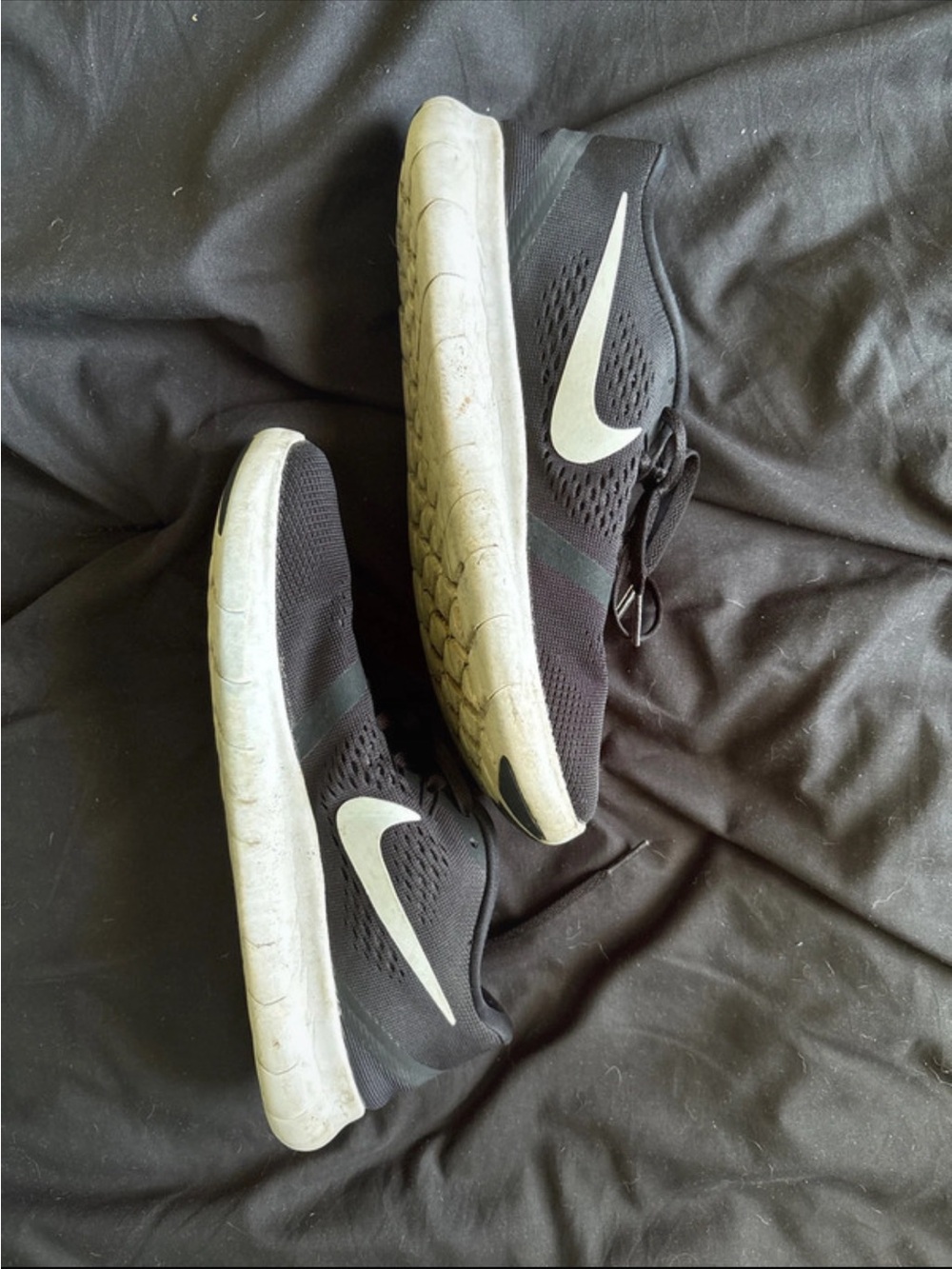 Black Nike shoes with white swoosh